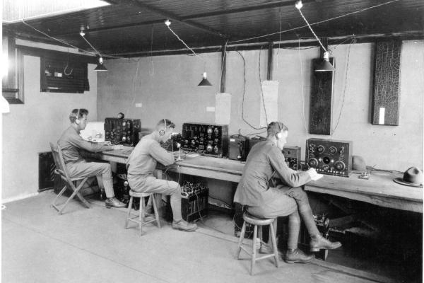 Three soldiers operating radio system
