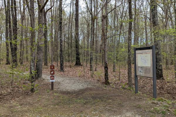 Trailhead to the Cowpens Nature Trail with a way side on the right in the woods.