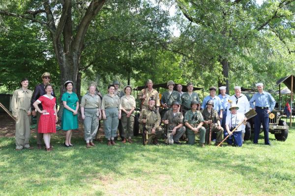 Large group of WWII-era living historians pose for a picture