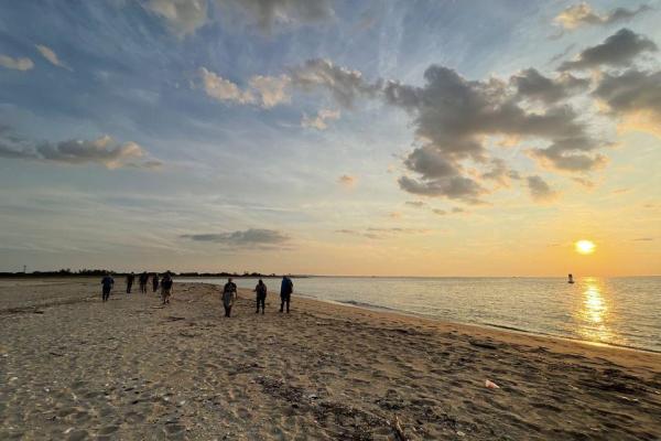 Group of people hiking on sand