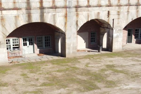 Interior of fort with curved doors and parade ground.
