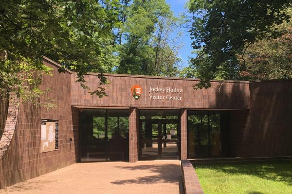 View of the front facede of the Jockey Hollow Visitor Center--a dark brown brick buildings