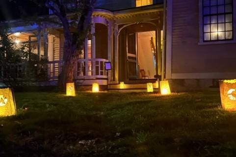The wayside front door with luminary bags leading to it.