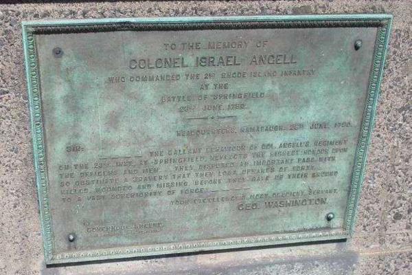 A bronze memorial plaque mounted on stone honors Colonel Israel Angell, featuring an engraved tribute letter from George Washington.
