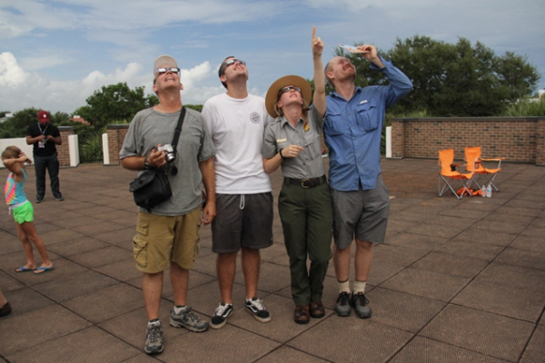 A ranger and visitors view the 2017 solar eclipse