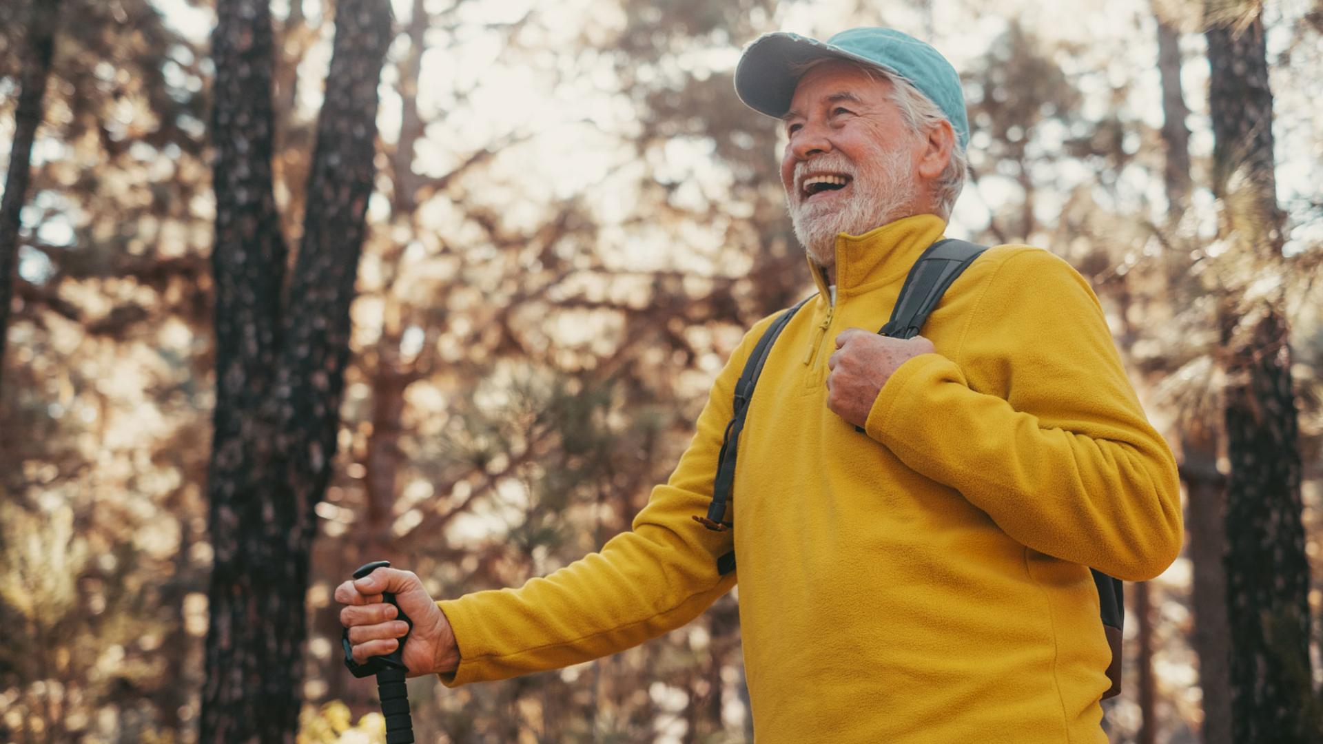 Image of an older man hiking in the woods