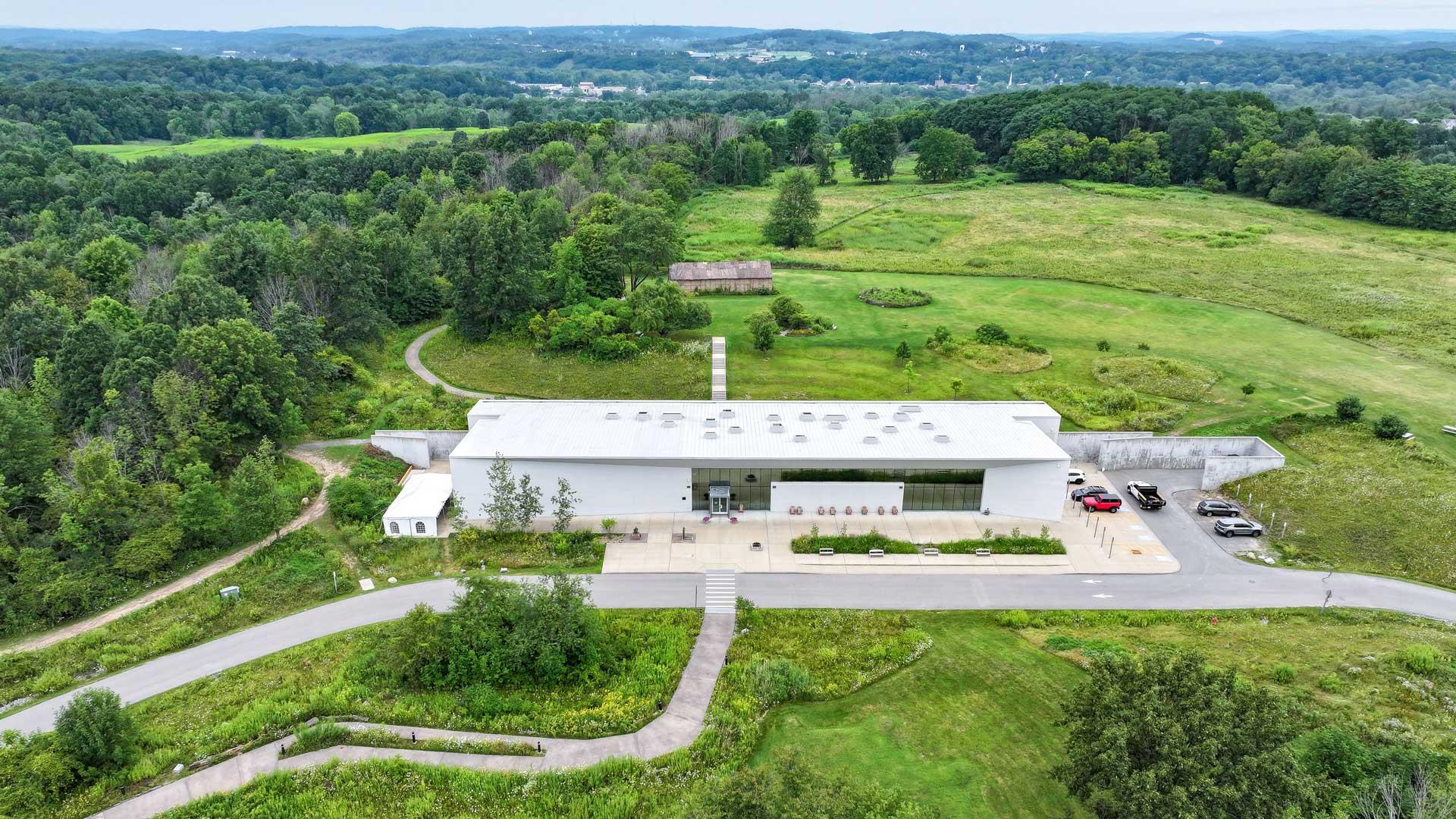 Aerial shot of Ganondaga State Historic Site with museum and longhouse in view