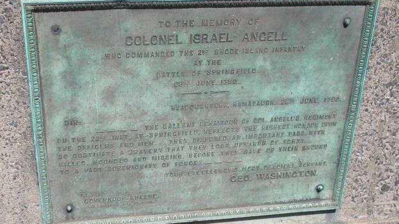 A bronze memorial plaque mounted on stone honors Colonel Israel Angell, featuring an engraved tribute letter from George Washington.