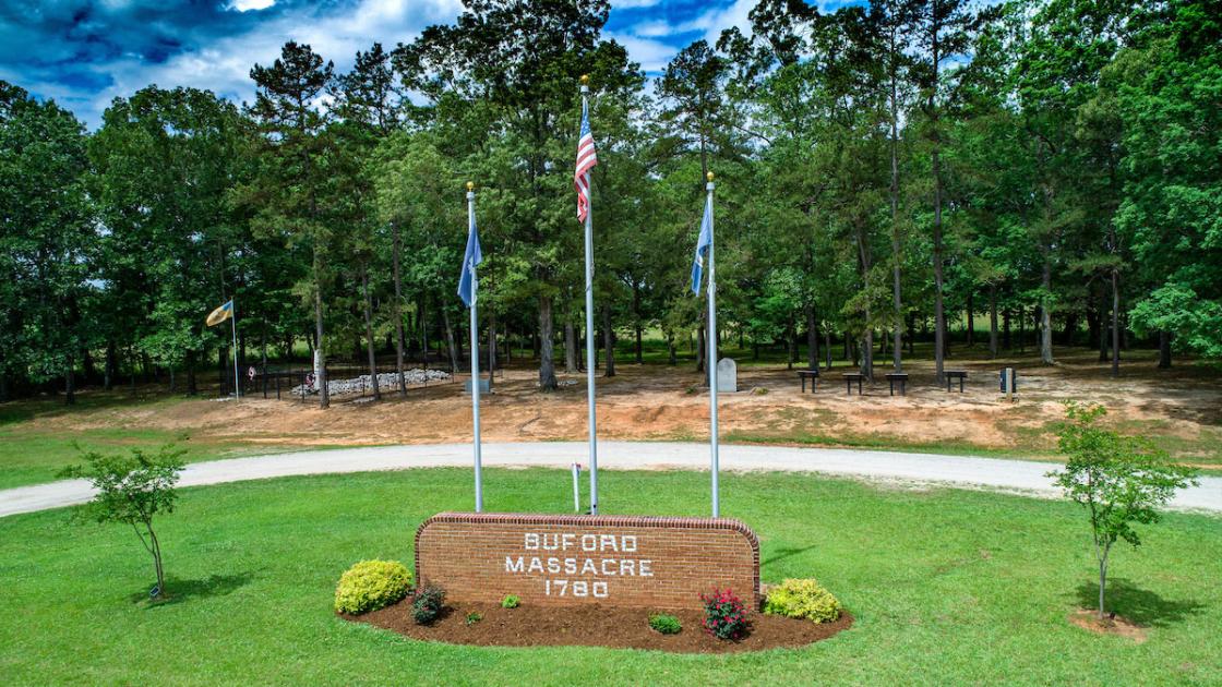 Image of the entrance memorial sign and flags denoting Buford Massacre 1780