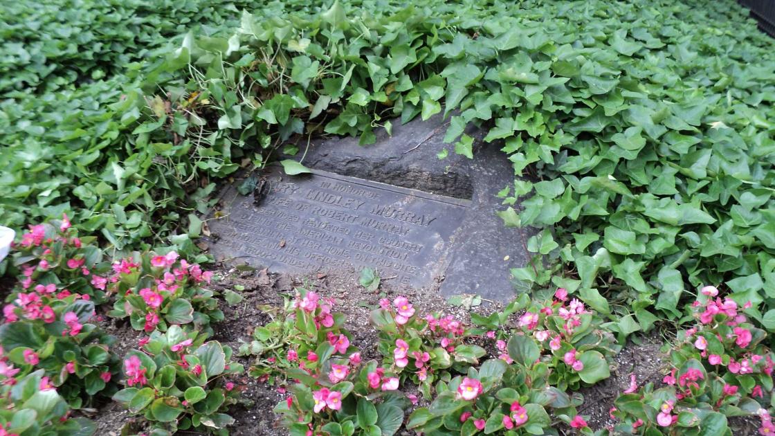 Mary Lindley Murray Monument surrounded by ivy and flowers