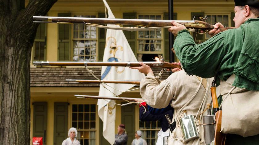 Re-enactors ready their weapons for a volley